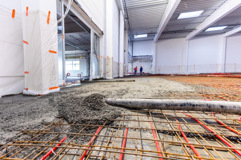 Concrete screed on floor heating in a new warehouse and office building